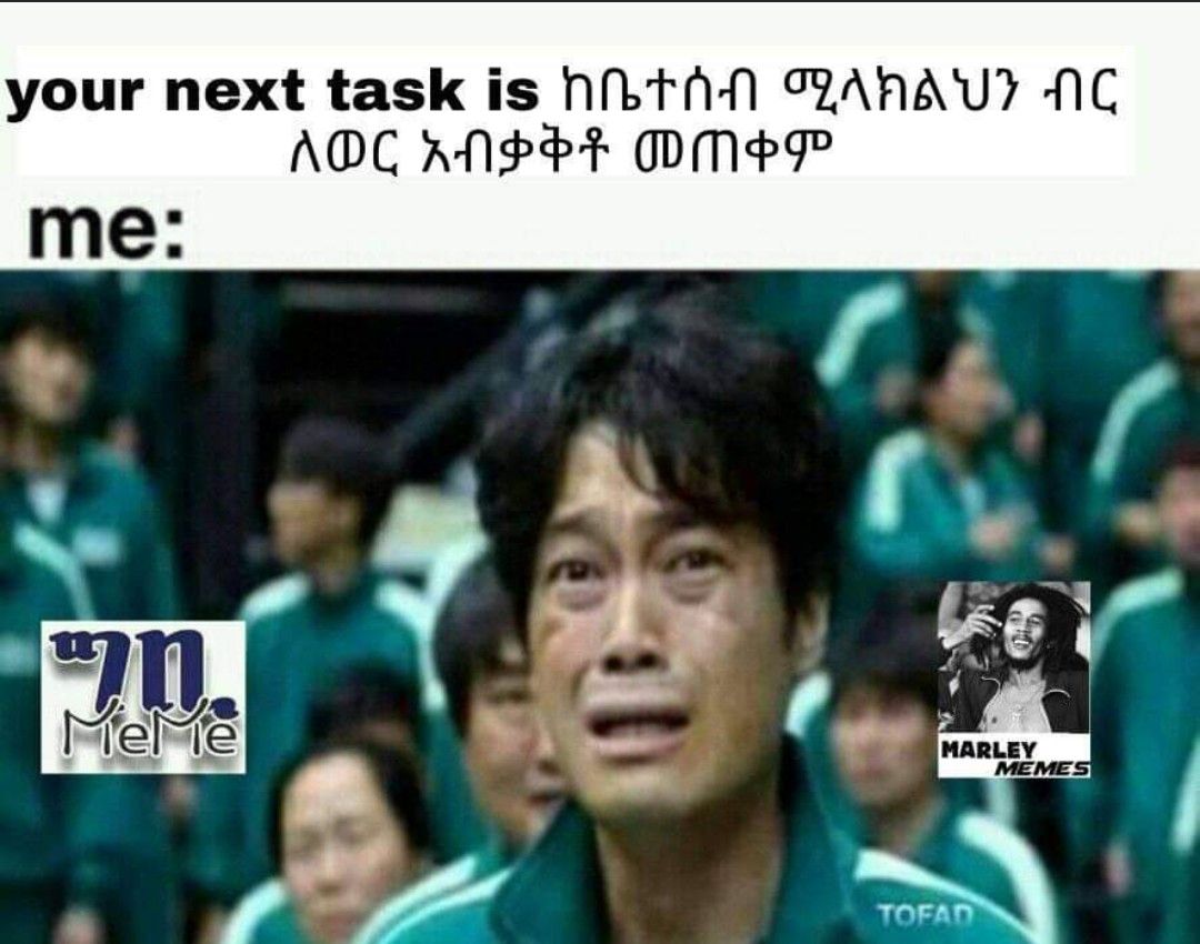 a man in a green shirt is standing in front of a crowd